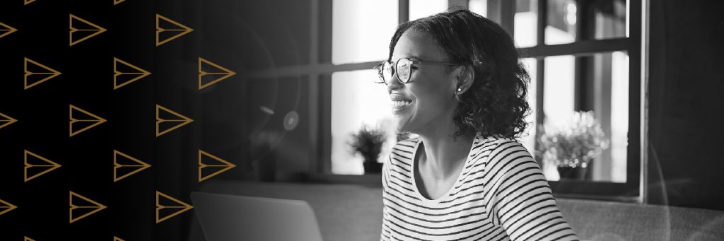 Side profile of smiling woman waring glasses and a striped shirt