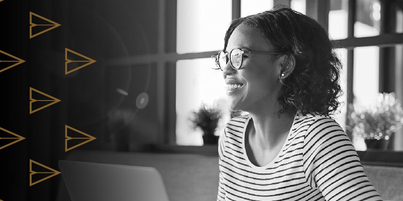 Side profile of smiling woman waring glasses and a striped shirt