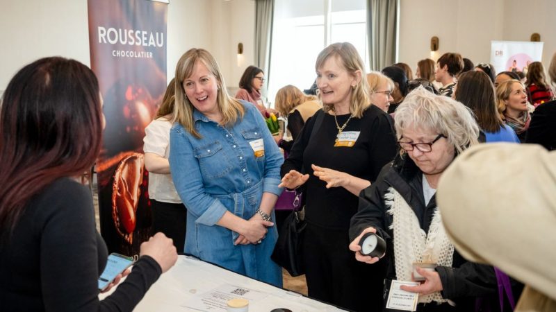A crowded gathering of professional business women networking